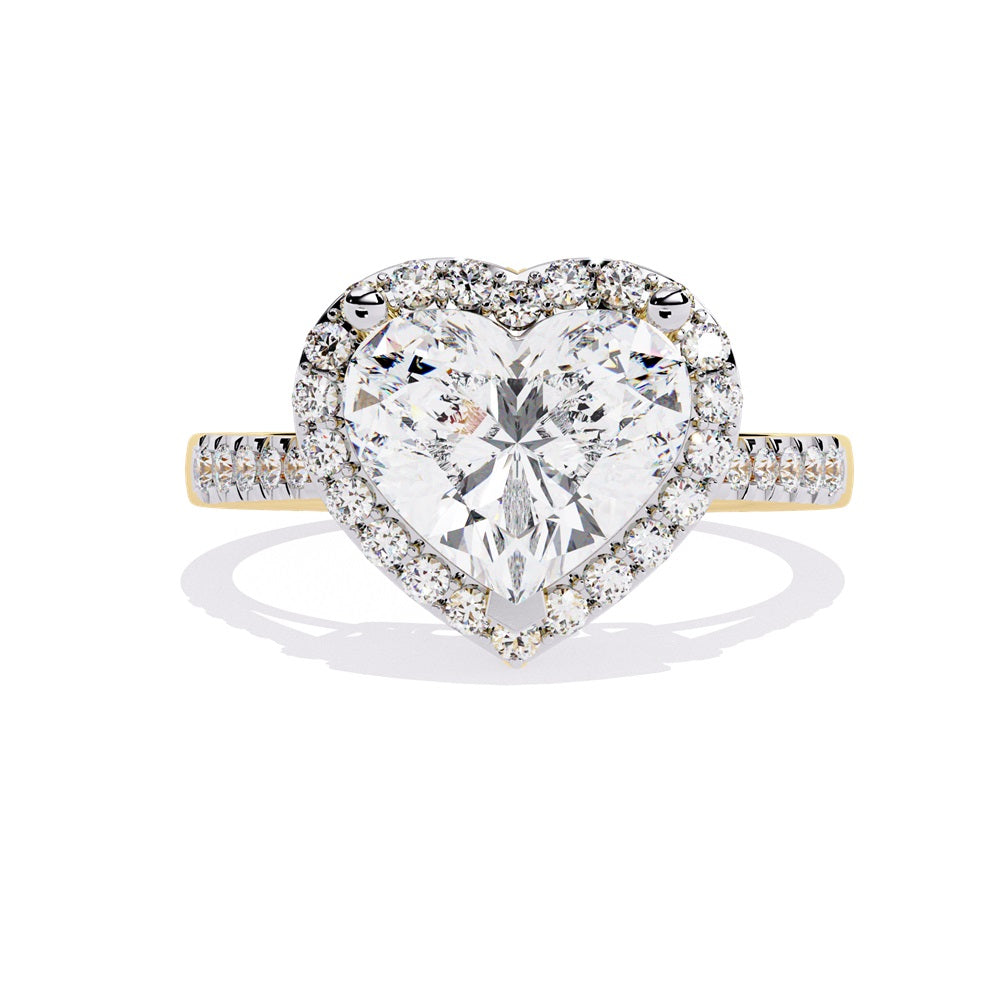 A heart-shaped diamond ring in gold, featuring a solitaire design with a halo of smaller diamonds surrounding it.