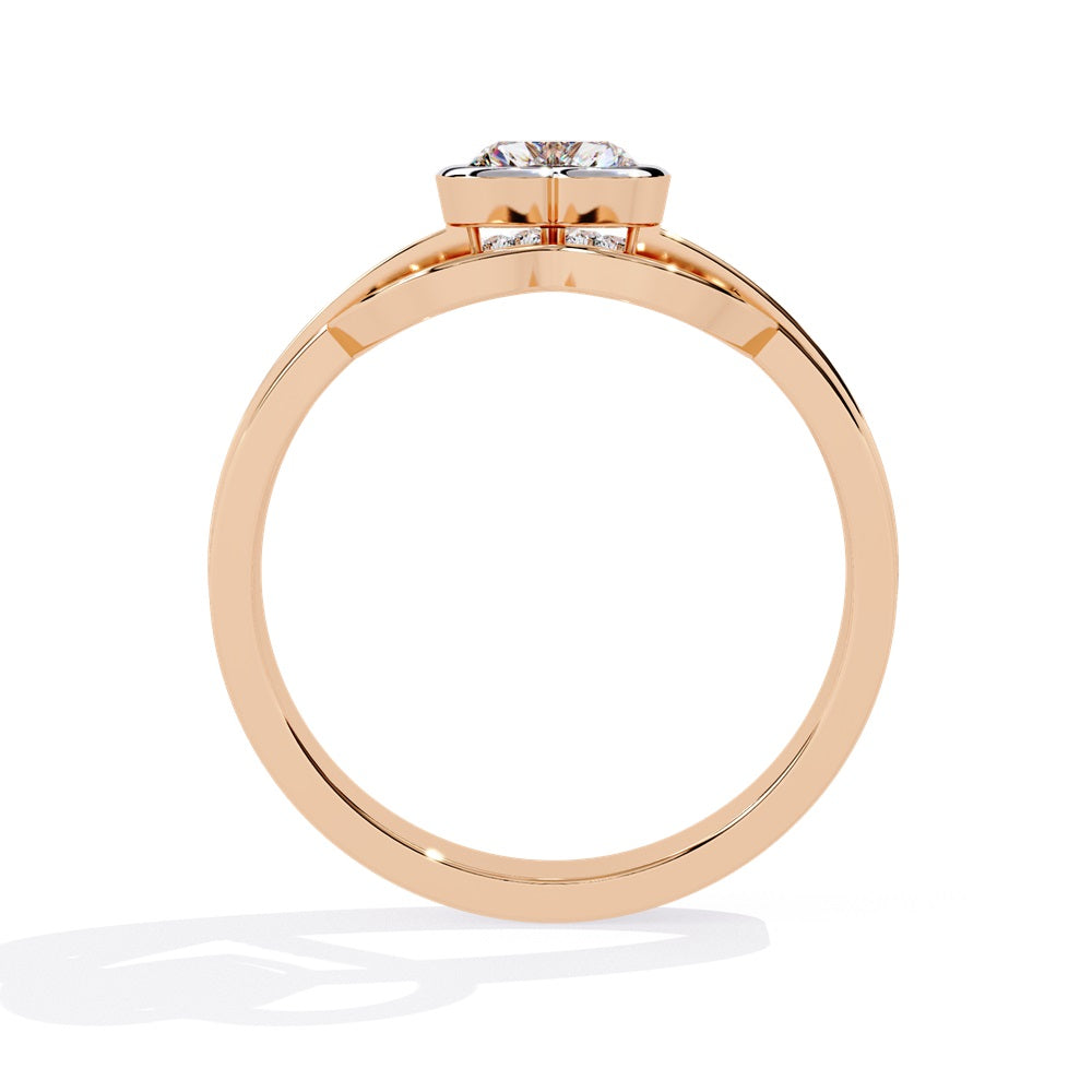 A heart-shaped diamond ring in gold, featuring a solitaire design with a gold halo surrounding it.