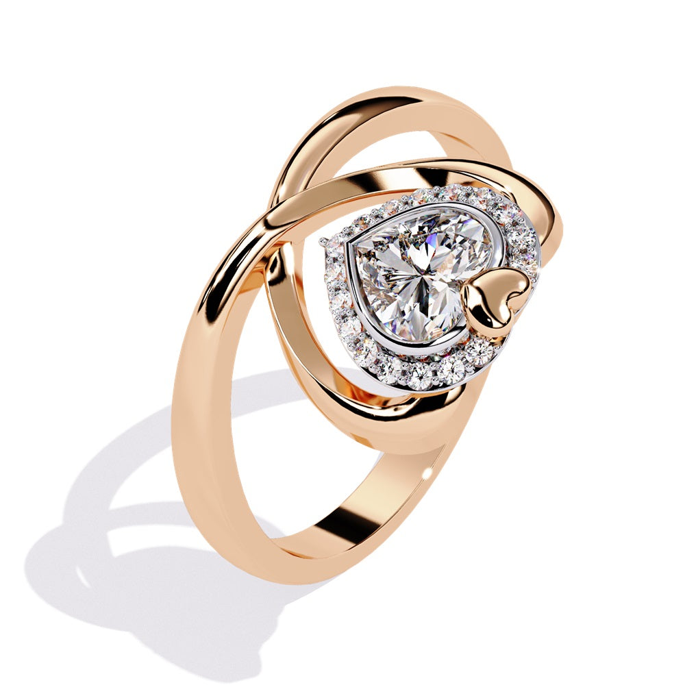 A heart-shaped diamond ring in gold, featuring a solitaire design with a halo of smaller diamonds surrounding it.