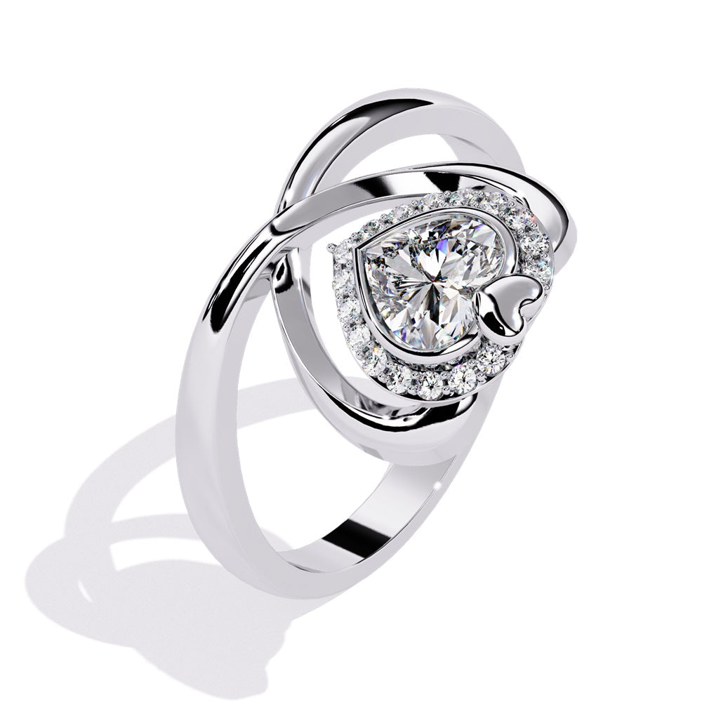 A heart-shaped diamond ring in gold, featuring a solitaire design with a halo of smaller diamonds surrounding it.