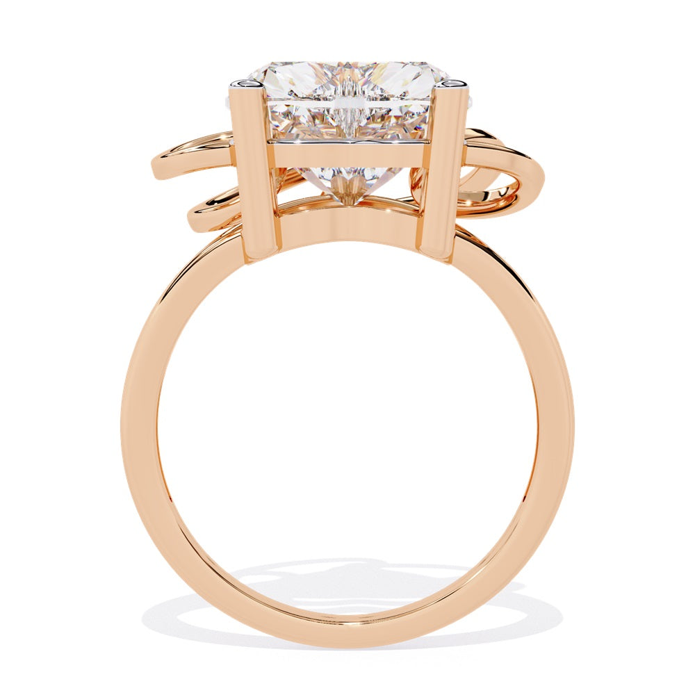 A heart-shaped diamond ring in gold, featuring a solitaire design featuring an intricate pattern below the heart.