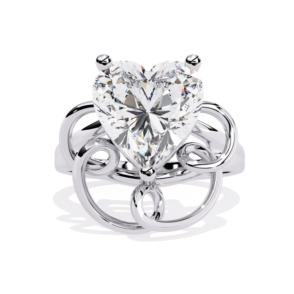 A heart-shaped diamond ring in gold, featuring a solitaire design featuring an intricate pattern below the heart.