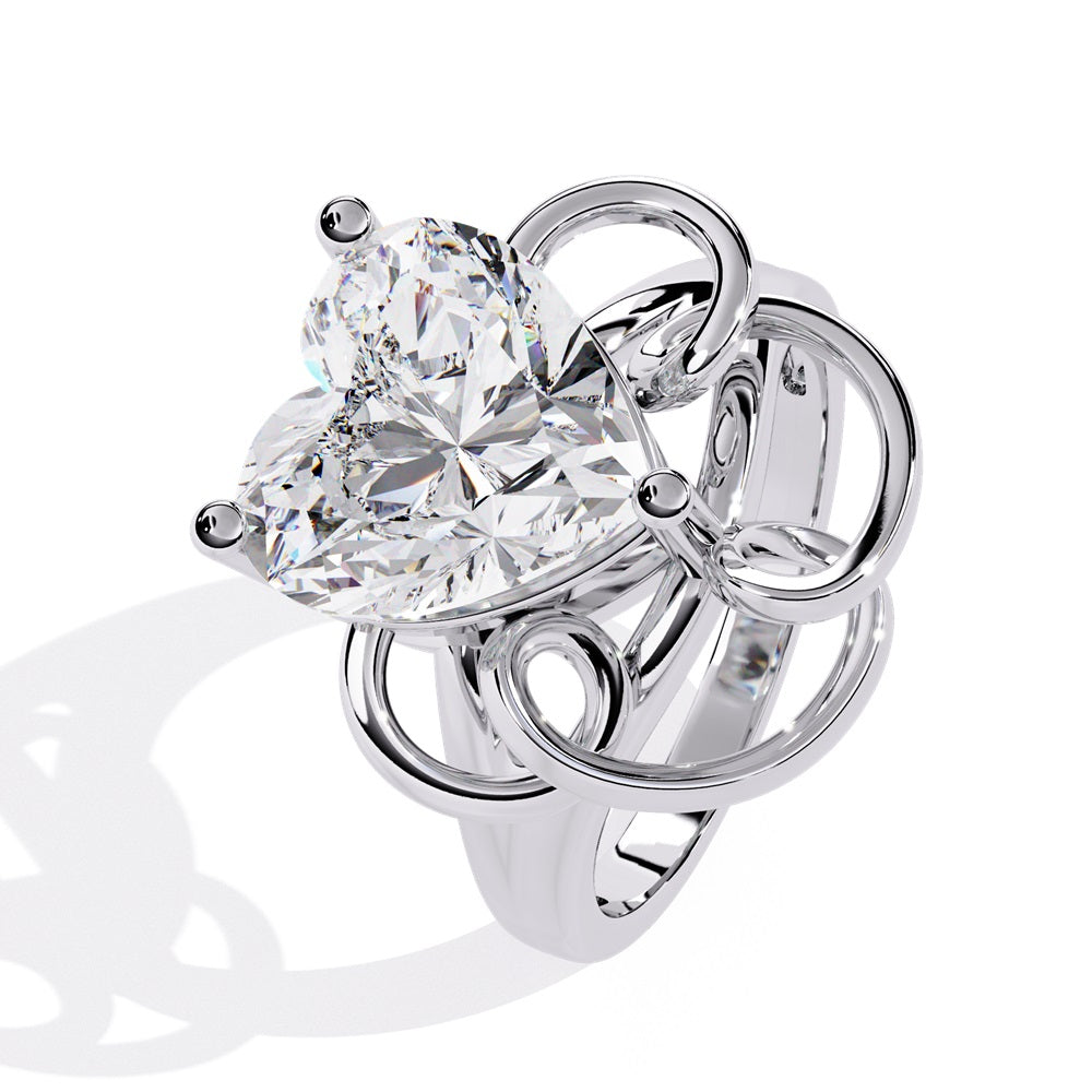A heart-shaped diamond ring in gold, featuring a solitaire design featuring an intricate pattern below the heart.