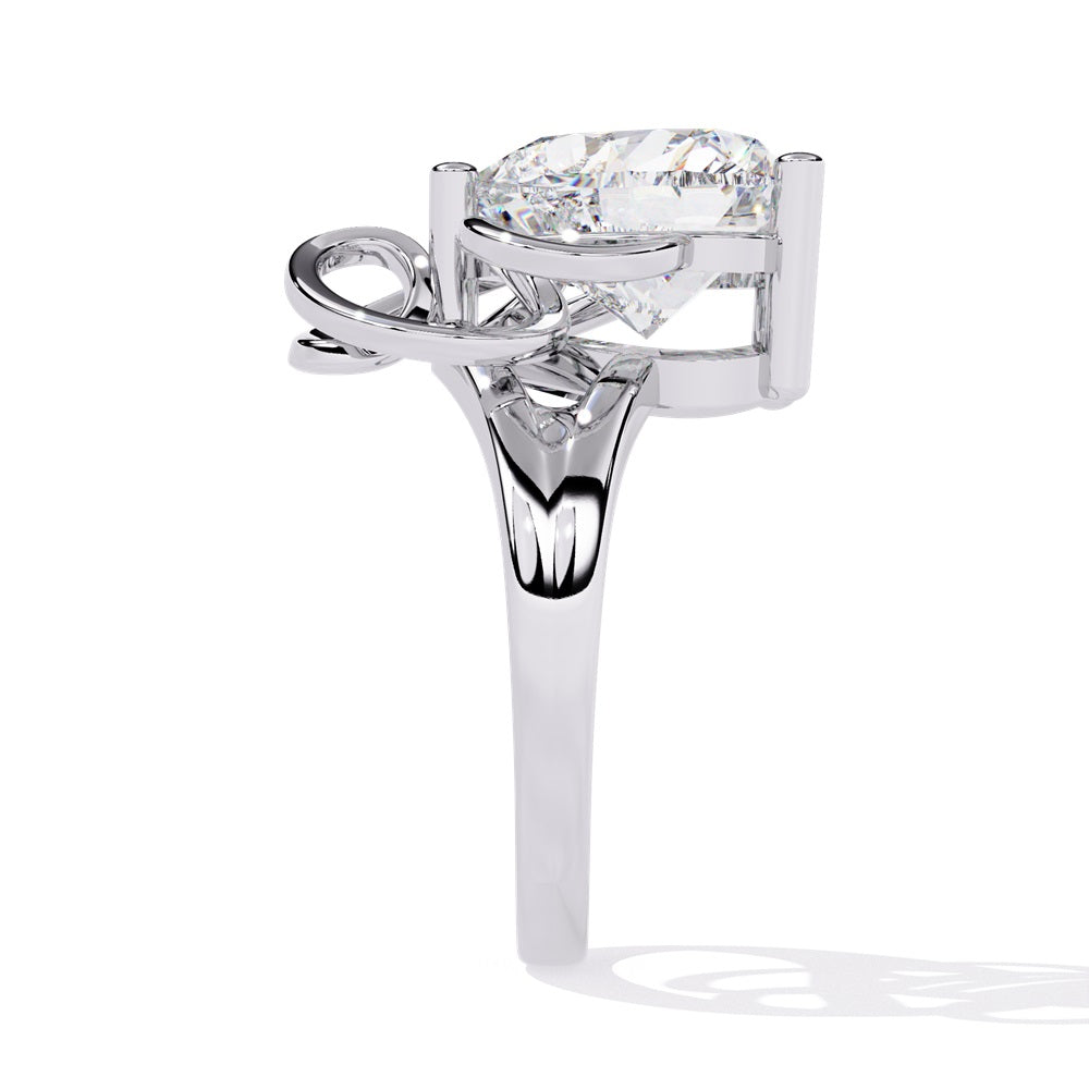 A heart-shaped diamond ring in gold, featuring a solitaire design featuring an intricate pattern below the heart.