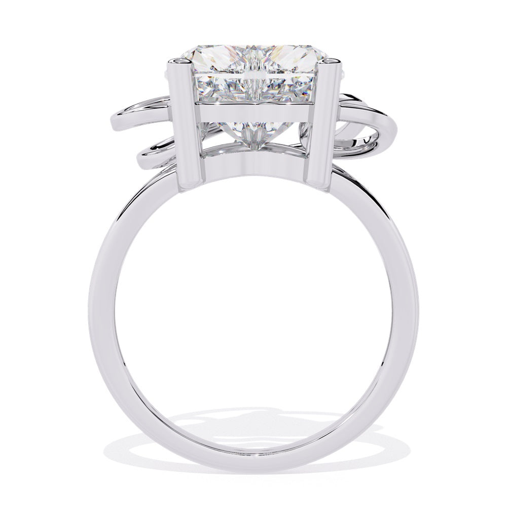 A heart-shaped diamond ring in gold, featuring a solitaire design featuring an intricate pattern below the heart.
