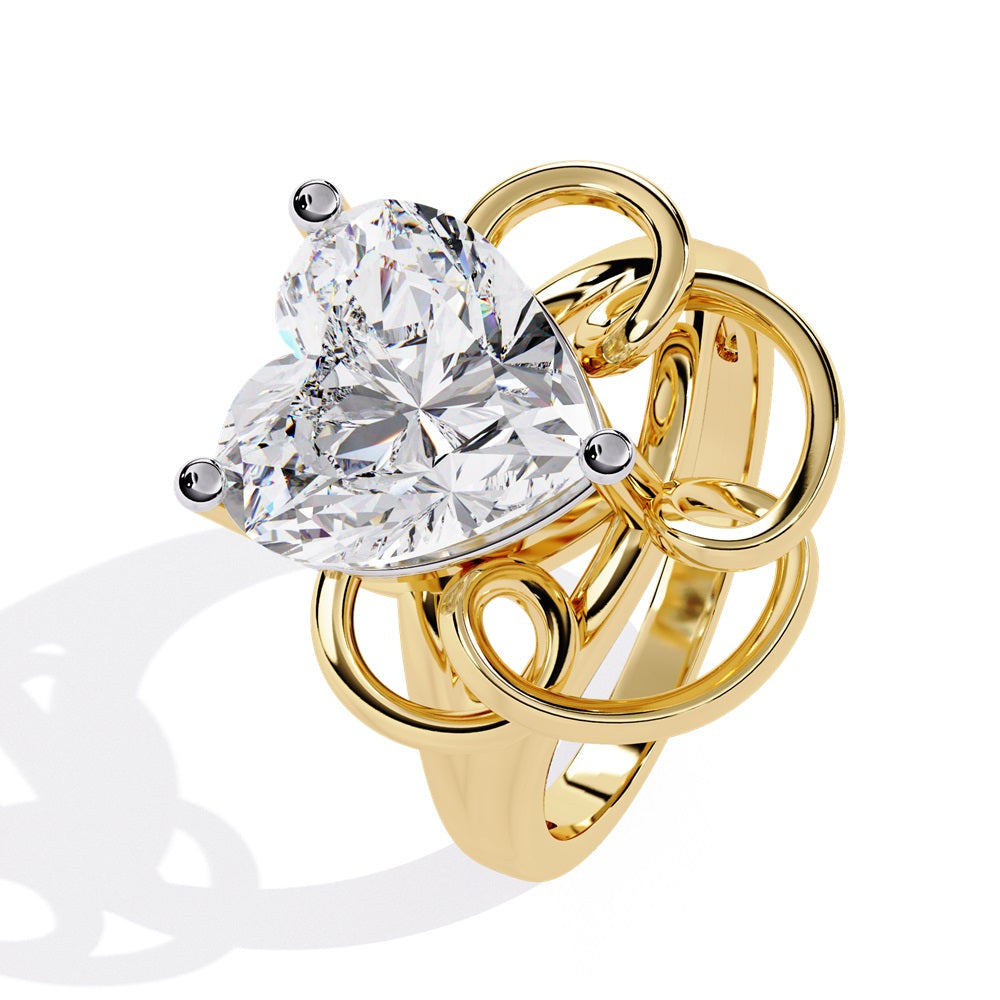 A heart-shaped diamond ring in gold, featuring a solitaire design featuring an intricate pattern below the heart.