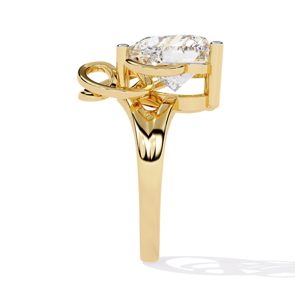 A heart-shaped diamond ring in gold, featuring a solitaire design featuring an intricate pattern below the heart.