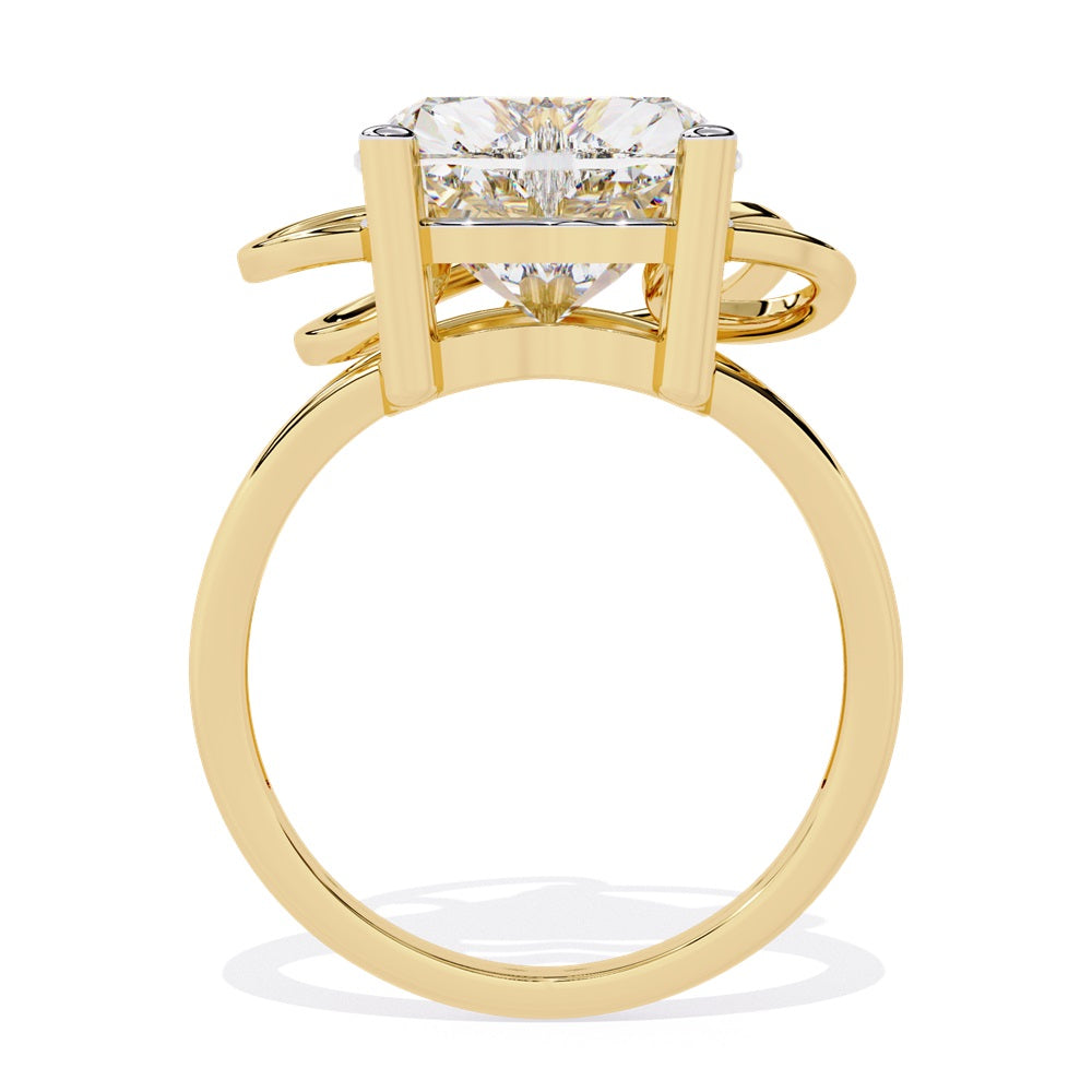 A heart-shaped diamond ring in gold, featuring a solitaire design featuring an intricate pattern below the heart.