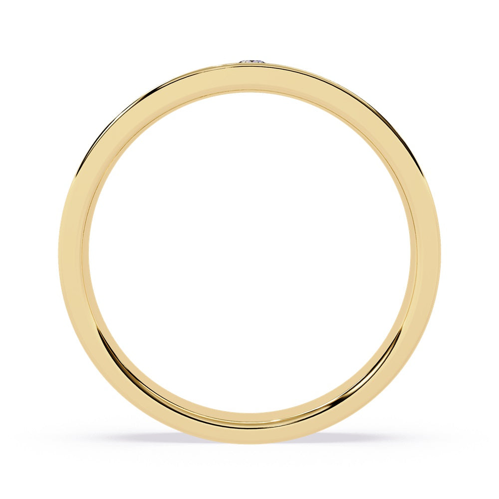 Two elegant gold wedding bands adorned with diamonds, symbolizing love and commitment for a couple.