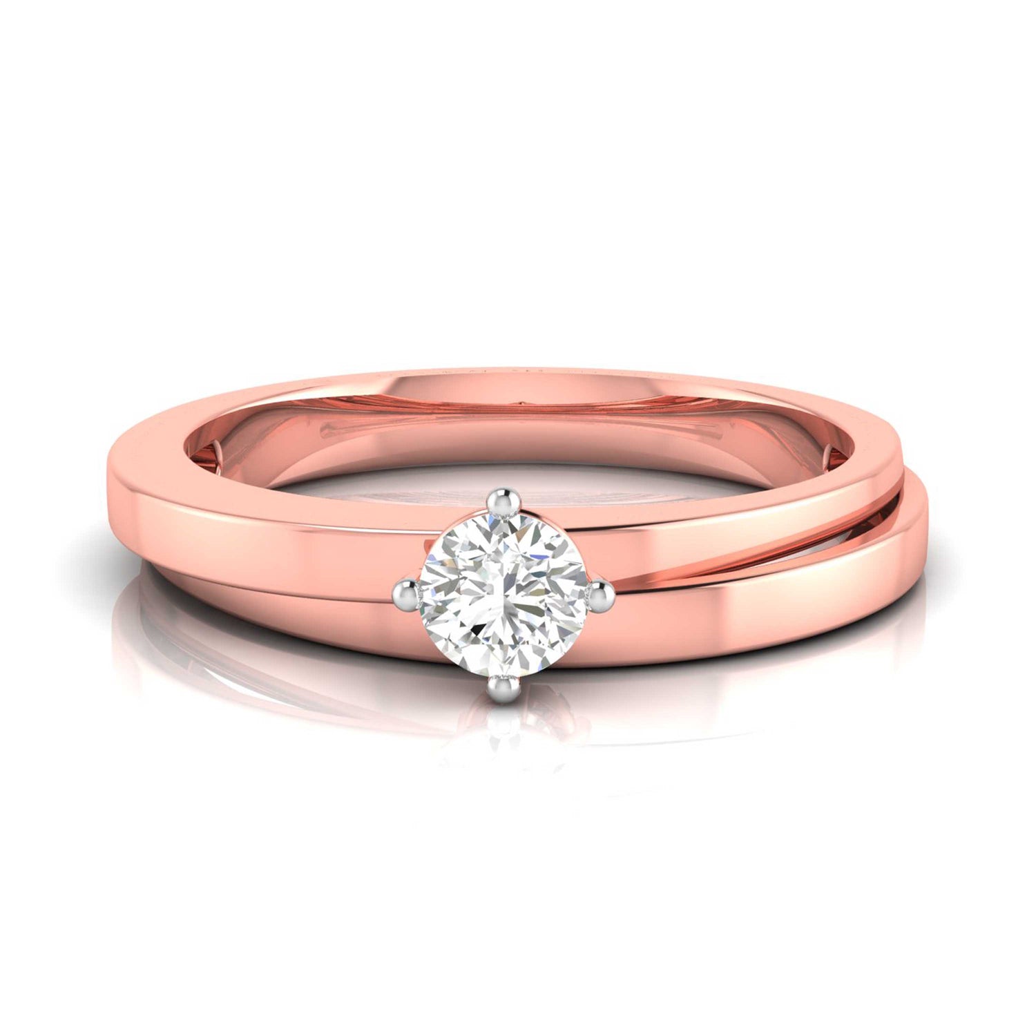The Hailey Diamond Solitaire Ring by Niraa is a luxury rose gold engagement ring with a round, brilliant-cut diamond in a classic prong setting. Its polished band enhances the diamonds allure as it elegantly rests on a reflective surface.