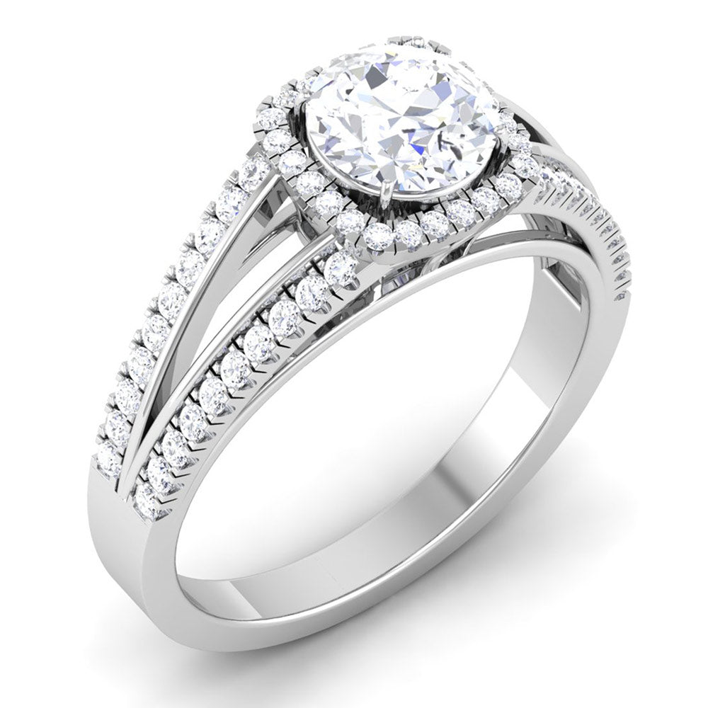 The Edna Diamond Solitaire Ring by Niraa features a captivating round central diamond encircled by a halo of smaller gems. The silver band splits gracefully, with each side adorned with delicate diamonds that enhance the rings sophisticated design.