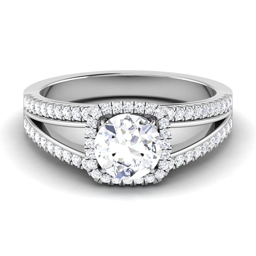 The Edna Diamond Solitaire Ring by Niraa features a captivating round central diamond encircled by a halo of smaller gems. The silver band splits gracefully, with each side adorned with delicate diamonds that enhance the rings sophisticated design.