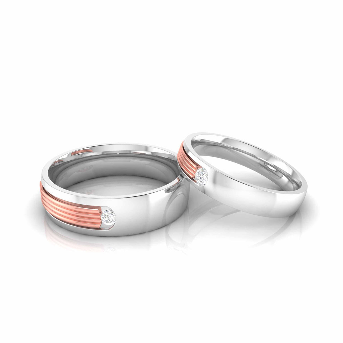 Displayed against a white background, two Irene Diamond Ladies Rings by Niraa feature sleek gold accents and small diamonds. The polished finish subtly reflects light, with one ring leaning against the other to highlight their modern design.