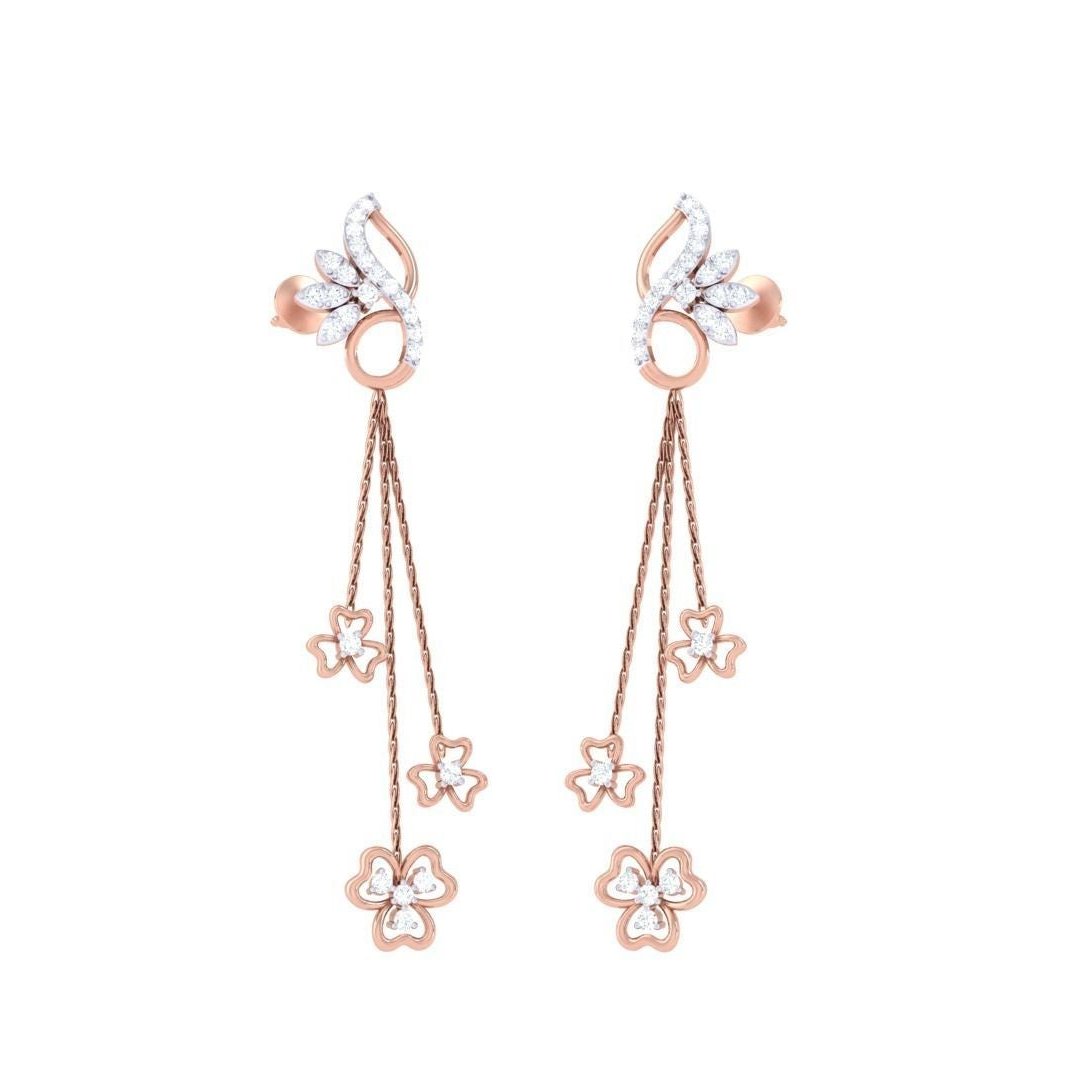 The Kaylee Diamond Earrings by Niraa feature elegant gold with a swirling design, leading to three cascading chains each adorned with flower-shaped charms, epitomizing timeless beauty.