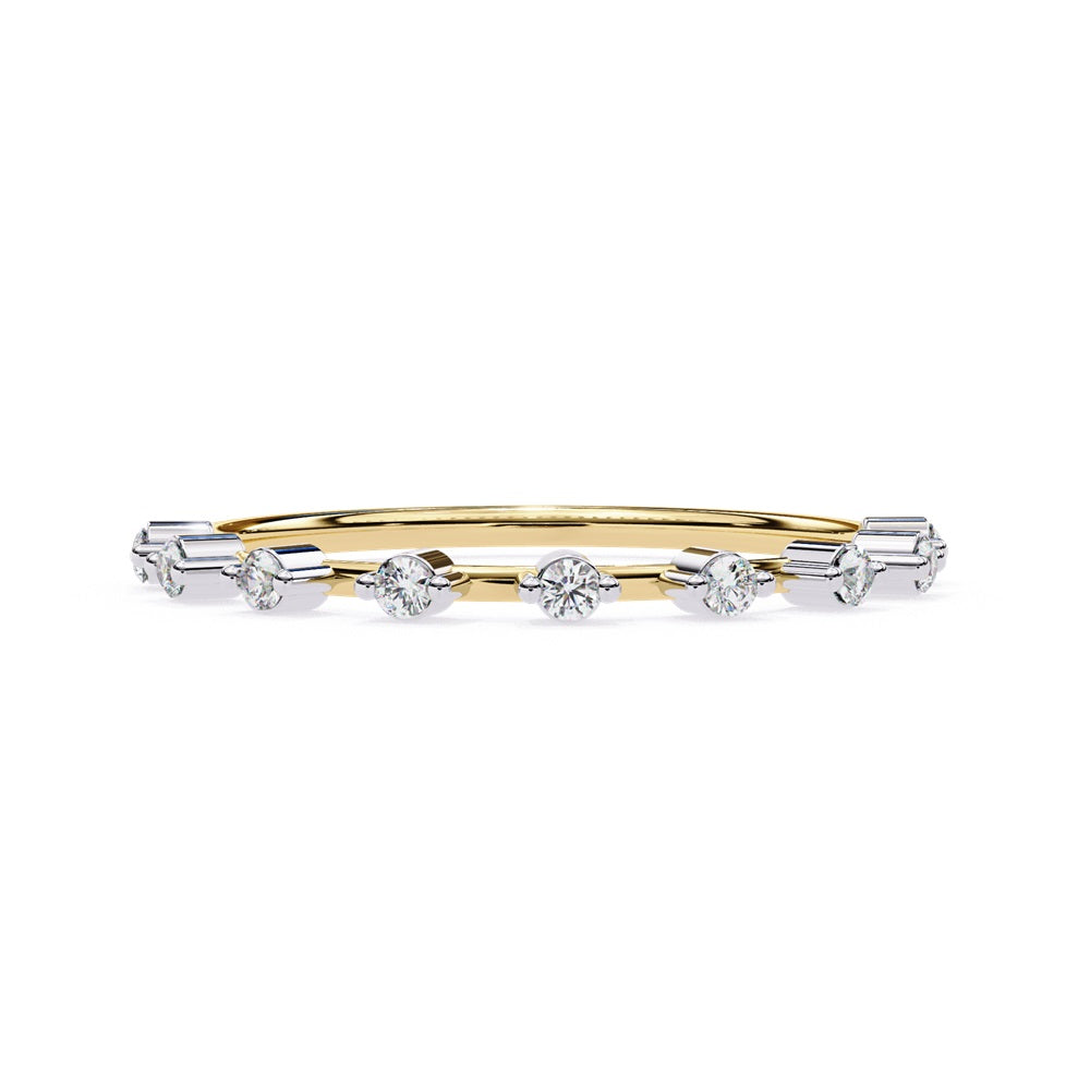 The Sunrise Diamond Band by Niraa is a luxurious gold ring featuring an elegant alternating pattern of round and baguette-cut diamonds set in a row, beautifully showcasing the sparkling gemstones against its smooth surface.