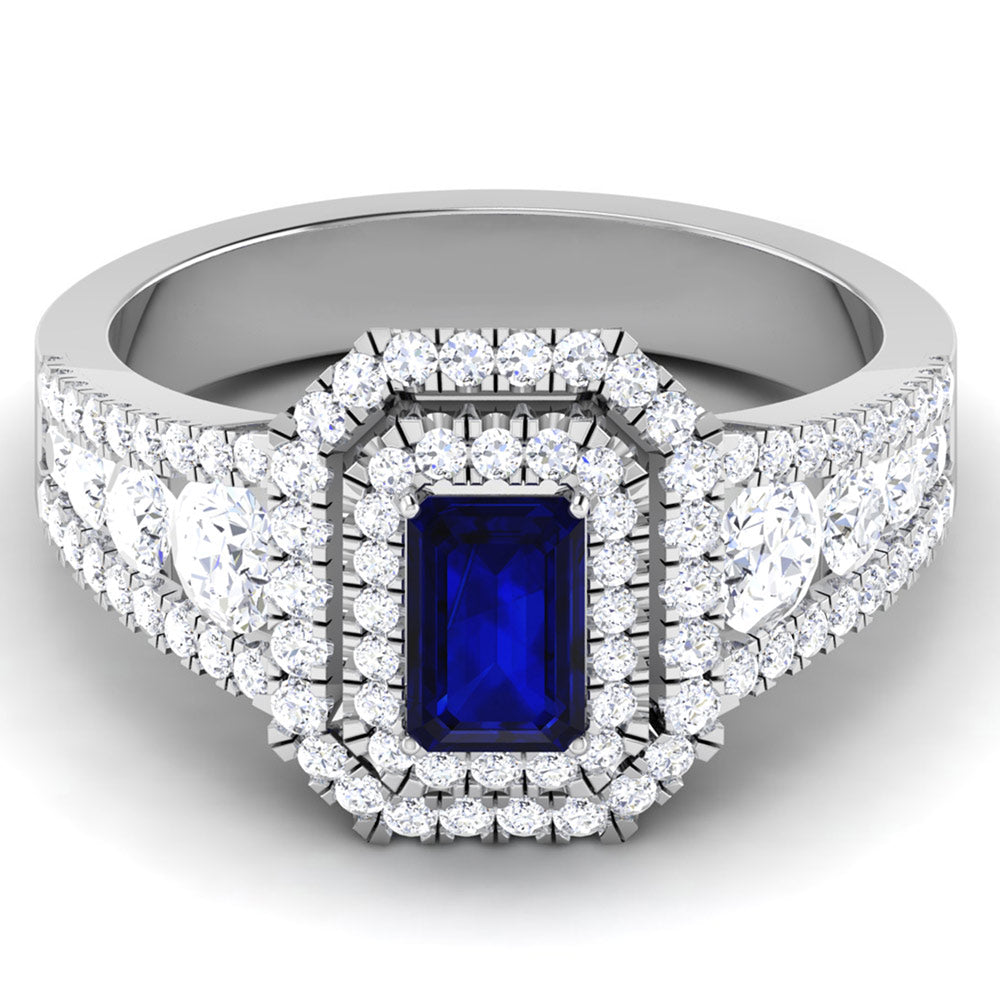 The Primrose Diamond Ladies Ring by Niraa is a luxurious silver ring featuring a prominent rectangular blue gemstone, framed by two rows of sparkling white diamonds. The diamond-encrusted band amplifies its elegance, epitomizing opulence and style.