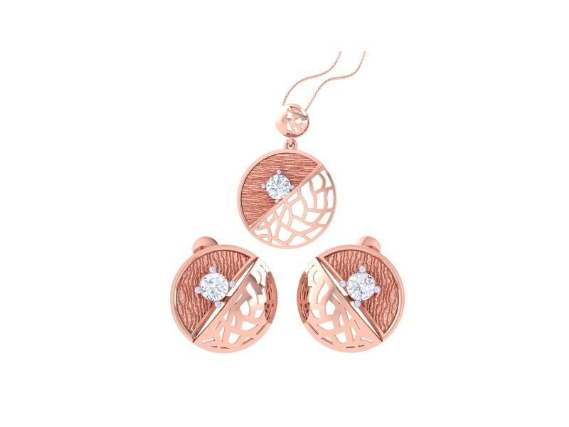 The Margot Diamond Solitaire Pendant Set by Niraa is a luxury accessory in rose gold, featuring a necklace and matching earrings with circular designs, textured surfaces, diagonal bands, and central rhinestones. The necklace elegantly hangs from a fine chain.